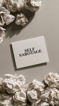 Self Sabotage Concept: A piece of paper with the words Self Sabotage written on it, surrounded by crumpled papers, symbolizing frustration and wasted effort.