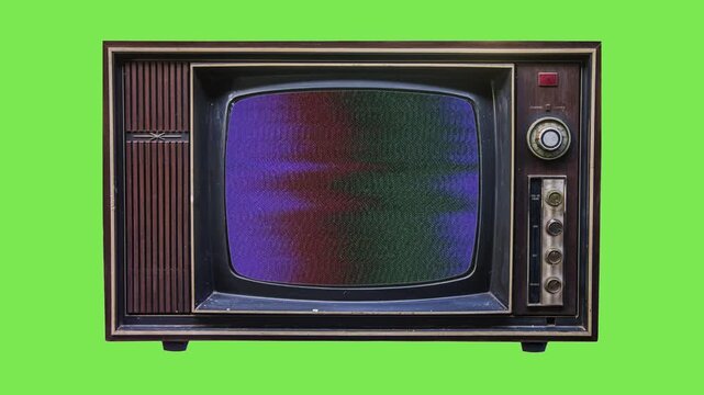 Vintage analog television set with static noise interference and signal distortion on a bright green chroma key background for video production