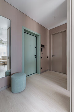 Modern Apartment Entryway Interior with Light Wood Flooring and Green Door
