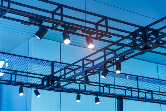 Directional LED lights on rails under the ceiling in a modern warehouse, shopping center building, office or other commercial real estate object.