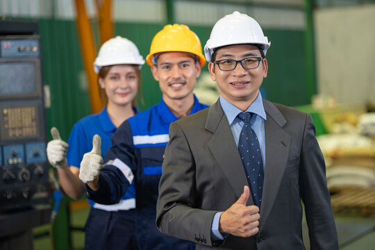 Team Workers with Business Engineer man Leader in a Factory. Teamwork and Professional Spirit in a Workplace Happy Thumbs up Smiling