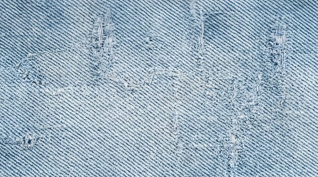 Bleached indigo denim fabric texture with distressed fiber weave