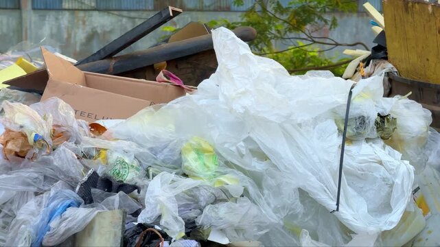 Pile of industrial garbage in an open field, illustrating environmental contamination, waste accumulation, and poor waste management practices.