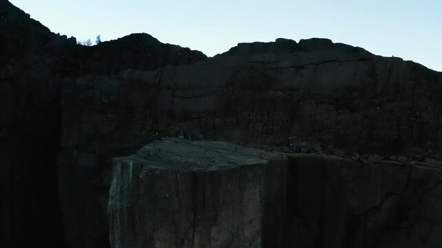 Dark columnar basalt rock formations in quarry landscape showing mineral extraction