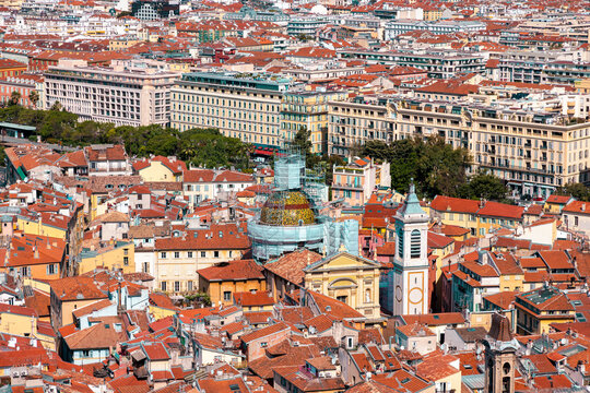 Aerial view of the historic Old Town of Nice, featuring the Cathedrale Sainte-Reparate with its tiled dome, surrounded by dense terracotta rooftops in Nice, Provence-Alpes-Cote d'Azur, France.
