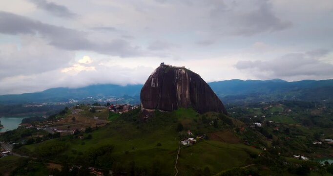 Aerial dolly toward iconic landmark of El Pe&ntilde;ol inselberg in Guatape Colombia