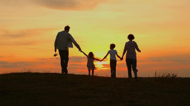 Family Walking Together at Sunset