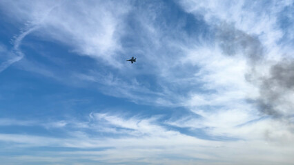 Fototapeta premium Military Jet Flying Through Wispy Clouds at Avalon Airshow