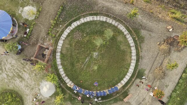 Aerial footage showing people visiting Batashi Park, a small rural amusement park in Ujan village, Kushtia. The overhead view captures the park's attractions, paths, landscaped areas, and surrounding 