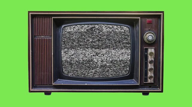 Old vintage television set displaying white noise analog static on the screen isolated over a solid bright lime green background