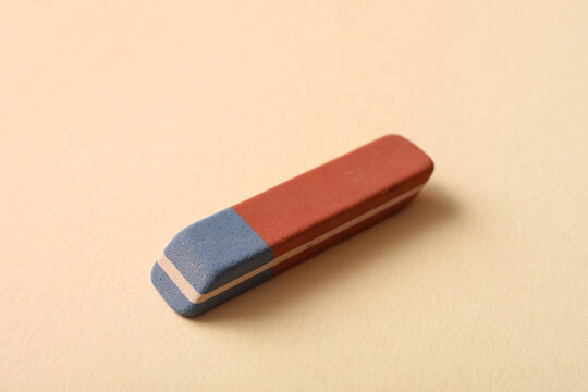 School eraser on light yellow background