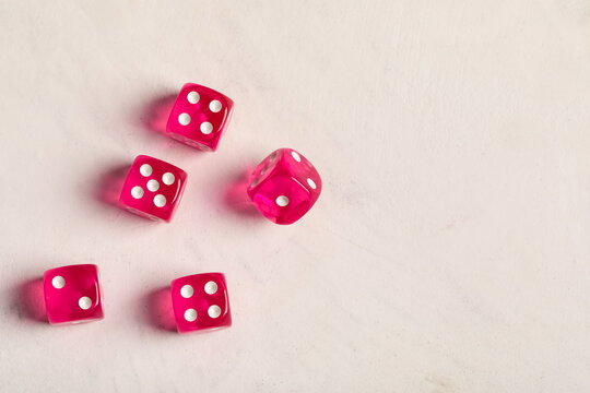 Pink game dices on white background