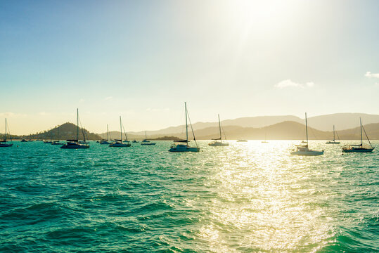 Idyllic sunset seascape with sailboats near of Whitsunday Islands, Australia