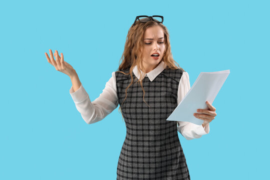 Beautiful actress with film script on blue background