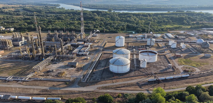 Aerial view of the South Industrial Zone featuring large storage tanks, refinery infrastructure, and pipelines situated near the Danube River in Pancevo, Serbia.