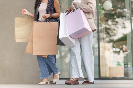 Cropped view of women holding paper shopping bags for Black Friday deal
