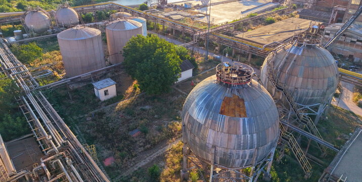 Aerial view of the South Industrial Zone featuring large spherical storage tanks and complex piping systems in Pancevo, Serbia.