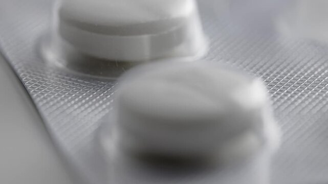 Close look at white tablets in packaging with details on their appearance