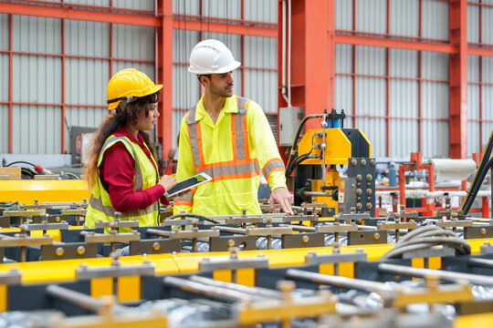 Engineers Collaborating on Industrial Equipment Analysis in Manufacturing for Safety Training and Educational Materials