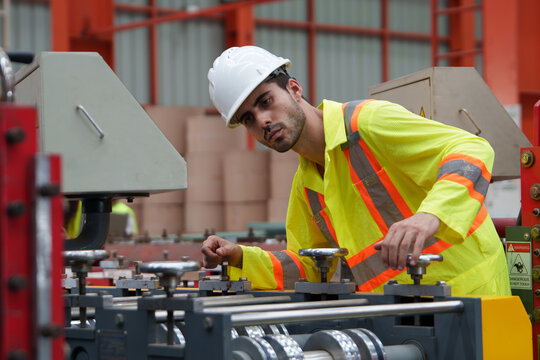 Technician Operating Machinery in Manufacturing Environment, Focusing on Safety and Machinery Operation for Industrial Applications