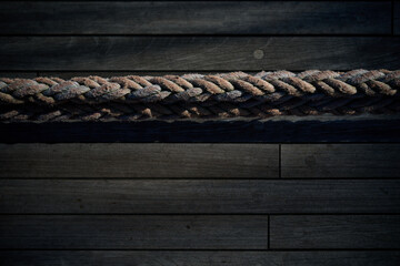 High angle view of a thick braided rope laid horizontally across a wooden ship deck, Gdynia, Pomerania, Poland, Europe © sebastiangora