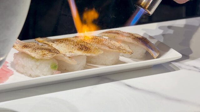Chef Searing Fresh Nigiri Sushi with a Blowtorch in Kanazawa Japan