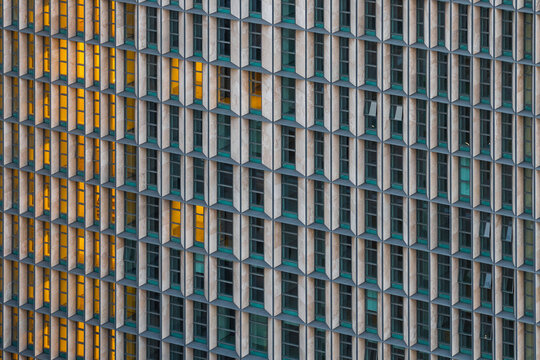 Aerial view of the geometric facade of a modern building in the EUR district featuring repetitive window patterns and stone cladding in Rome, Lazio, Italy.