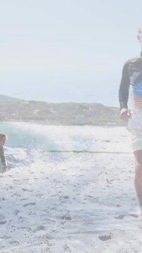 Animation of caucasian surfer sunning over waves and surfing man in background