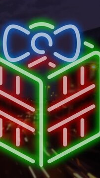 Animation of christmas present over cityscape at night