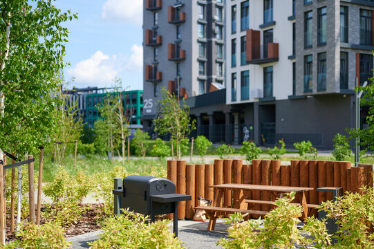 Outdoor barbecue area with picnic table in a modern residential park