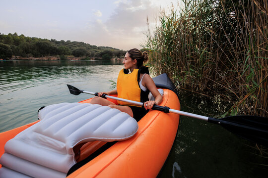 Woman kayaking on lake enjoying outdoor adventure