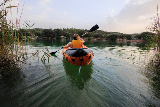 Woman kayaking on tranquil lake exploring nature
