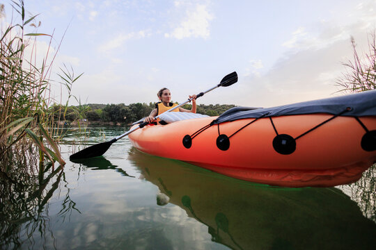 Woman kayaking on lake enjoying outdoor adventure