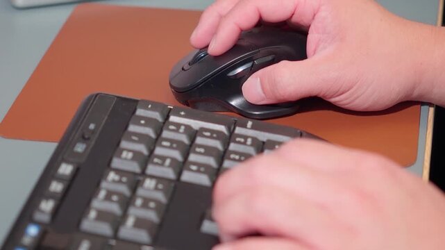 Office Worker Hands Using Computer Mouse and Keyboard Close Up