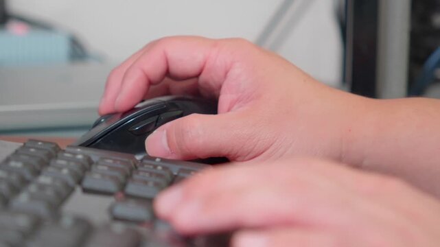 Office Worker Hands Using Computer Mouse and Keyboard Close Up