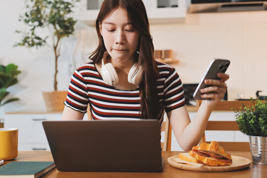Asian woman using computer remote for business studying, watching online virtual webinar training meeting, video call. asian business woman talking on laptop in home office. Banner, copy space