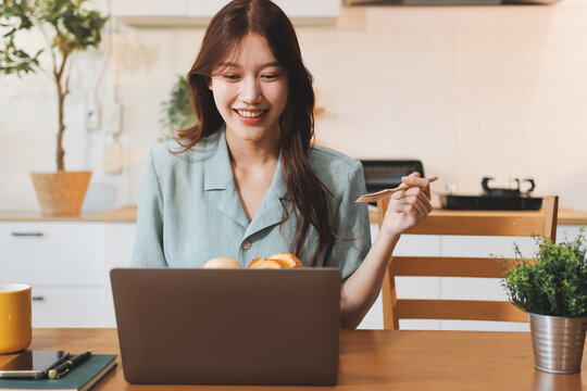Happiness Entrepreneur beautiful business asian young woman wear casual use mobile phone for shopping online enjoy with social media and laptop at home.Small Business Startup.online banking