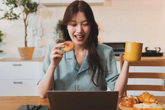 Happiness Entrepreneur beautiful business asian young woman wear casual use mobile phone for shopping online enjoy with social media and laptop at home.Small Business Startup.online banking