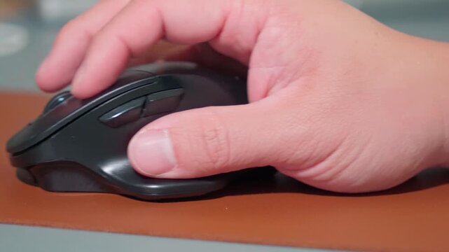 Close Up Man Hand Using Ergonomic Wireless Mouse at Office Desk