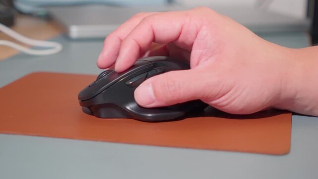 Close Up Man Hand Using Ergonomic Wireless Mouse at Office Desk