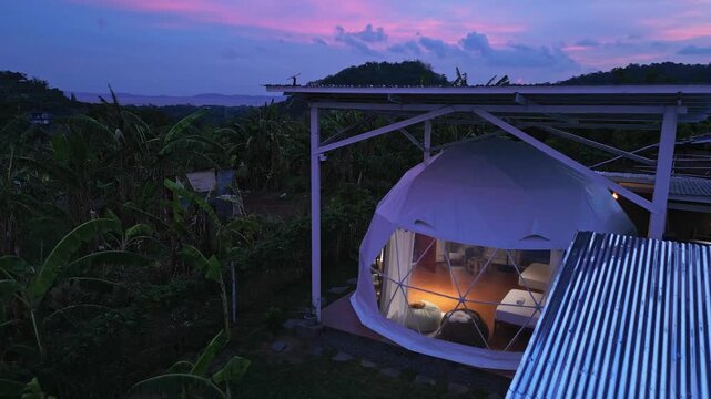 Magic sunset drone footage of a mountain dome accommodation in Pililla Rizal showcasing La Hacienda Hills 3 surroundings, green hills, and Philippine countryside.