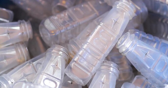Used clear PET plastic bottles in a recycling bin. plastic waste management, sustainability, circular economy, and environmental conservation concepts, close-up