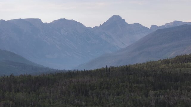 Aerial of Uinta Mountain Range and valleys and forests in Summit County Utah in summer with hazy sky