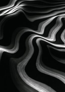 Black and white abstract background with wavy lines that create a sense of movement and depth.