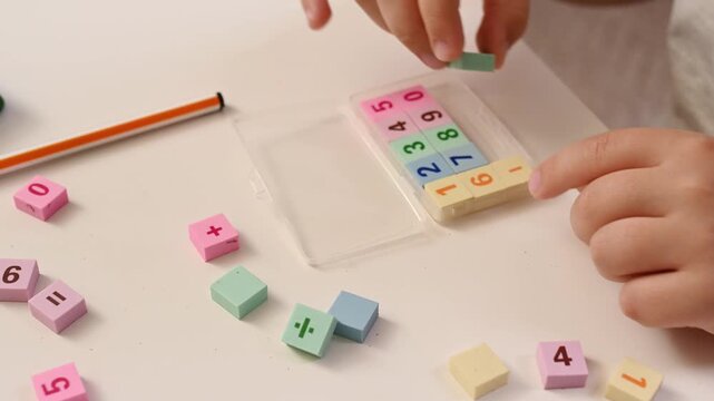 Hands close-up of Boy play with Colorful Math Blocks at Home, Early Childhood Education, STEM Learning, Homeschooling, Cognitive Development, Learning Through Play mathematics and counting top view