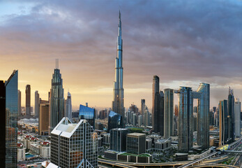 Naklejka premium Dramatic sunrise over Dubai skyline panorama with Burj Khalifa and luxury skyscrapers, United Arab Emirates