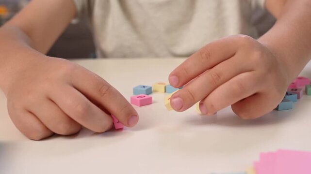 Hands close-up of Boy play with Colorful Math Blocks at Home, Early Childhood Education, STEM Learning, Homeschooling, Cognitive Development, Learning Through Play mathematics and counting