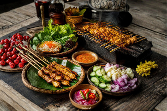 Authentic Southeast Asian Street Food with Grilled Satay Skewers, Fresh Herbs, Vegetables and Spicy Sauce