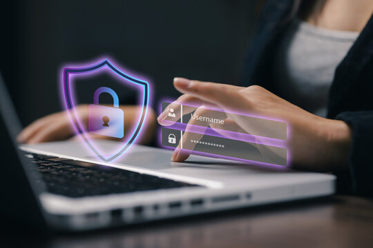 Businesswoman using laptop with glowing cybersecurity shield and login interface, representing password protection, authentication, privacy, data security, and secure online access.
