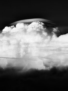 Convective sprouting Cumulonimbus clouds with lenticularis in spectacular black and white shot